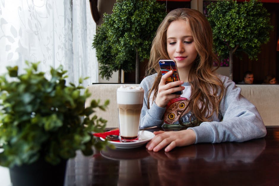 teen looking at her phone