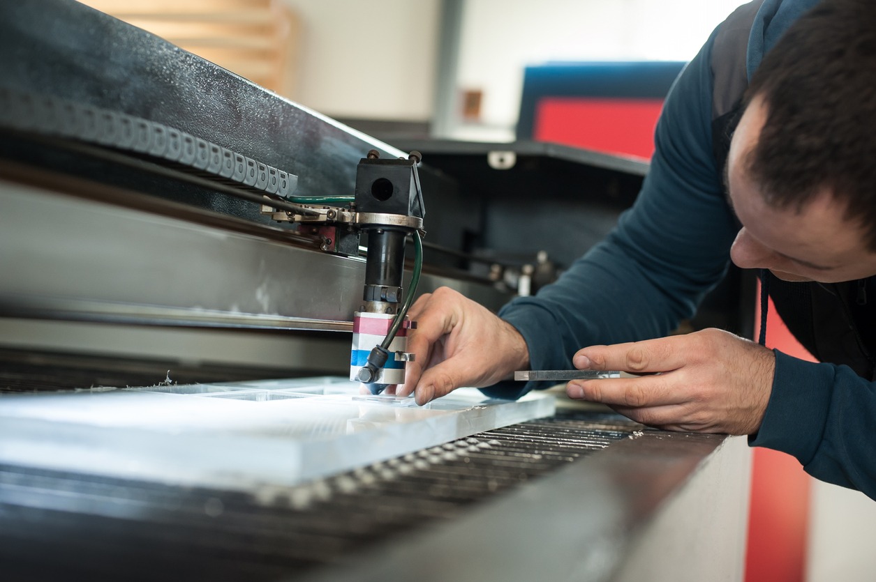 Electrical engineer repairs CNC computer numerical control laser cutting head