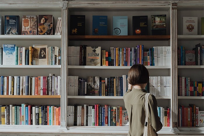 Woman picking a book