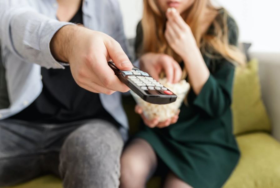 A man holding a remote control