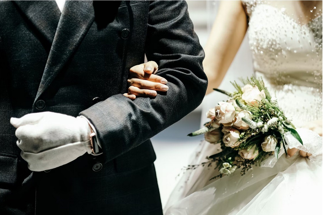 the bride holding on to her father at the wedding